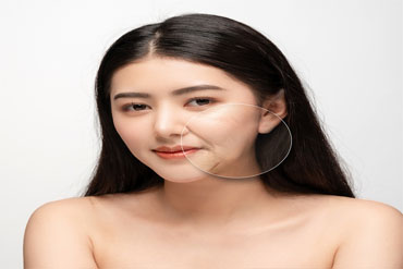 A woman with a radiant white face and clear skin, showcasing the results of Kaya by Reema Salon's facial services.