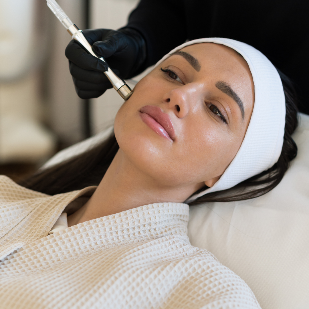A woman receiving a Hydro Boost facial treatment at Kaya by Reema Salon, showcasing anti-aging and organic peel services.
