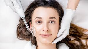 A woman undergoing a facial treatment at Kaya by Reema Salon, highlighting hydro boost and organic peel services for skin care.