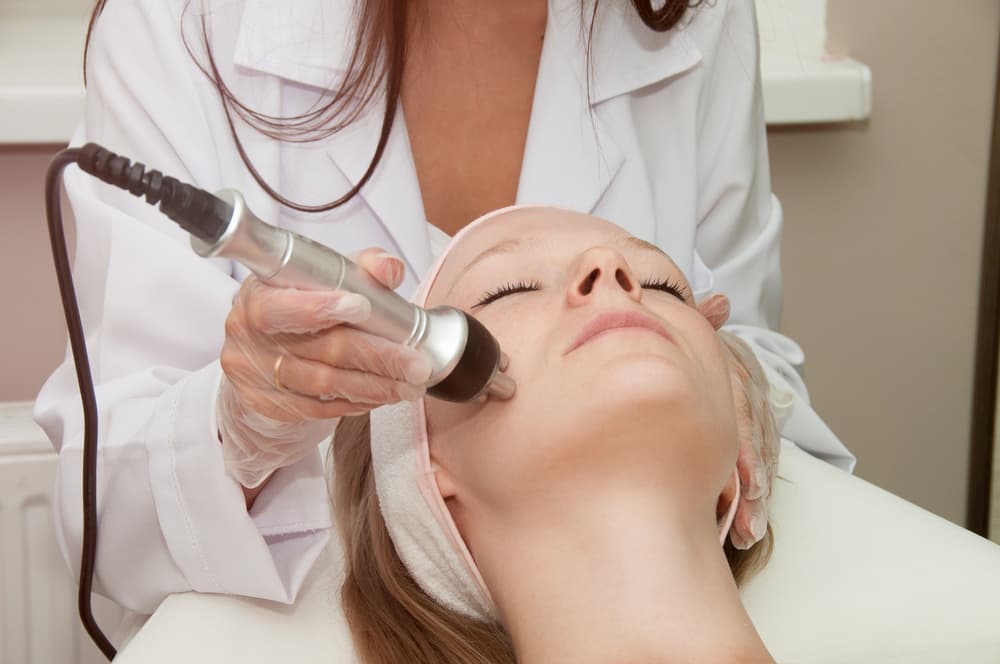 A woman receiving a Hydro Boost facial treatment at Kaya by Reema Salon, showcasing advanced skincare technology.