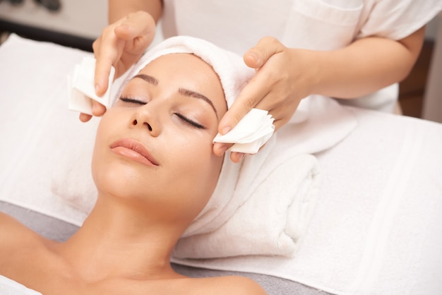 A woman experiencing a yoga facelift facial treatment at Kaya by Reema Salon, emphasizing wellness and relaxation in a spa environment.