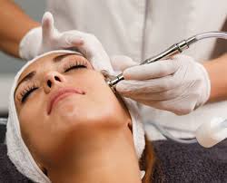 A woman receiving a Hydro Boost facial treatment at Kaya by Reema Salon, showcasing anti-aging and organic peel services.