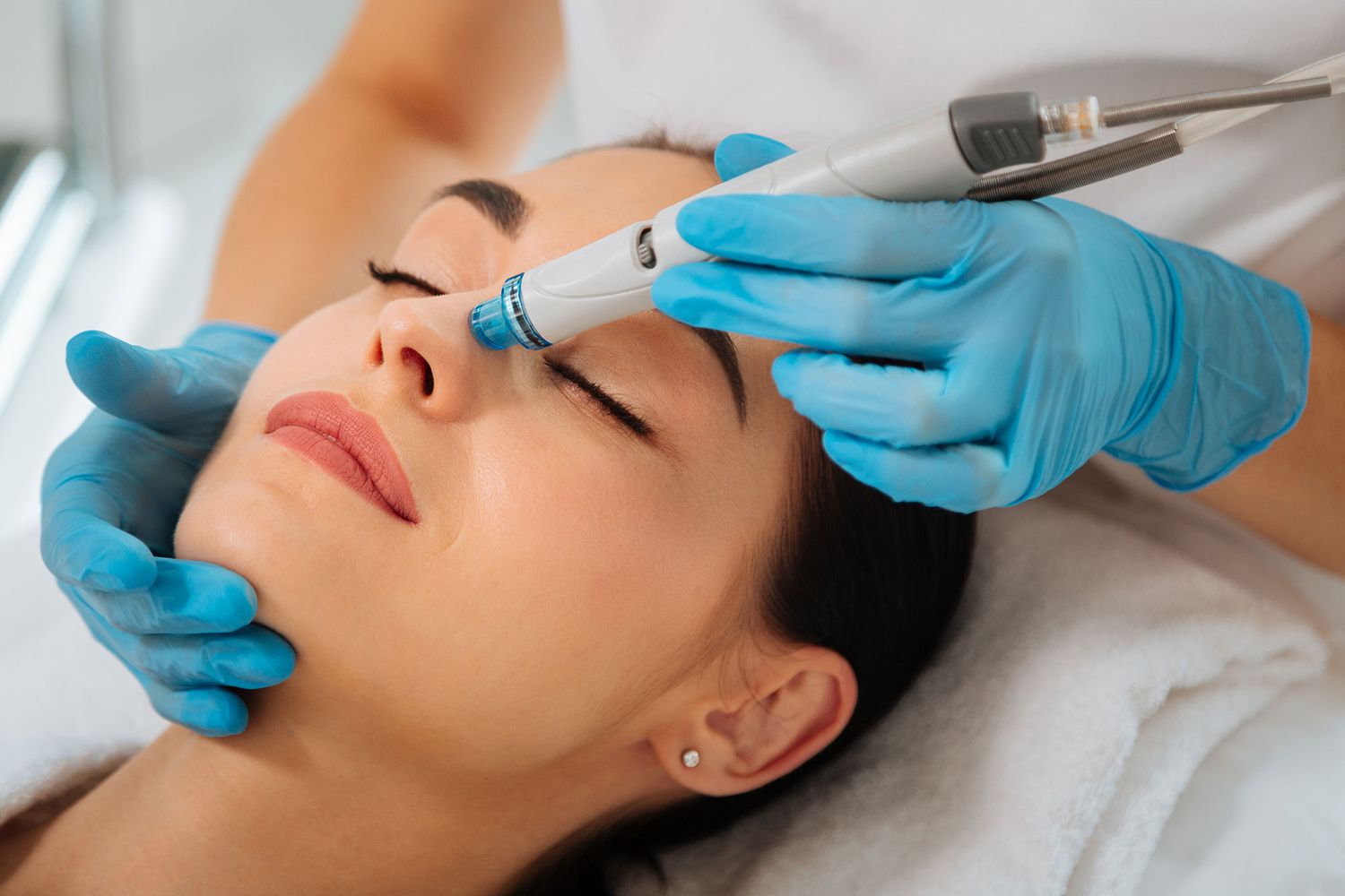 A woman receiving a laser facial treatment at Kaya by Reema Salon, showcasing advanced skincare techniques for anti-aging.